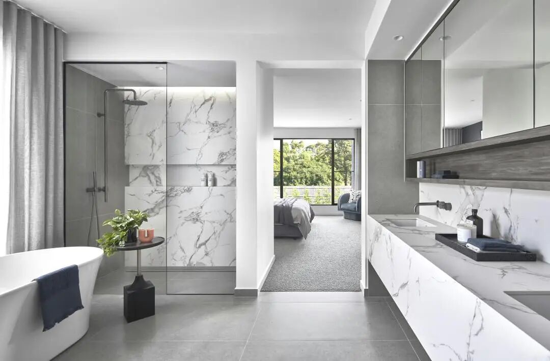 Modern bathroom design with freestanding tub, natural wood accents, and soft lighting creating spa-like retreat